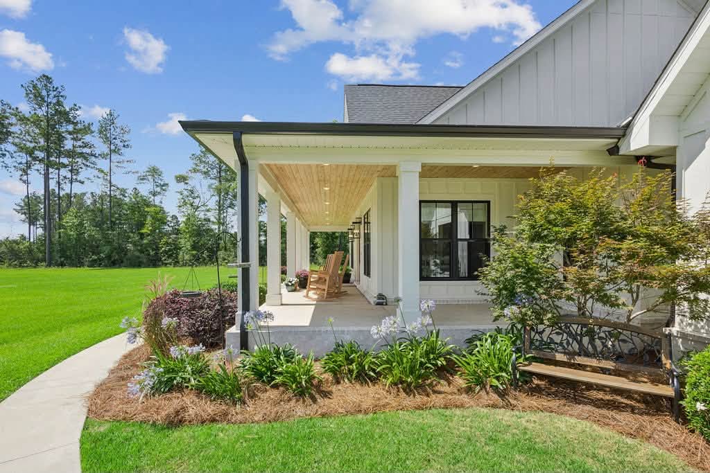 Welcoming farmhouse front porch overlooking the lawn